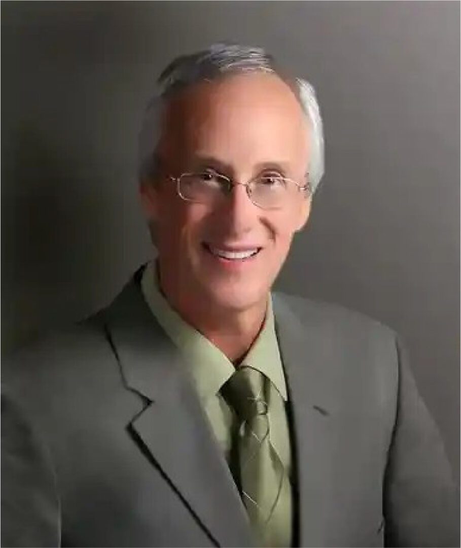 A man in a suit and tie wearing glasses.