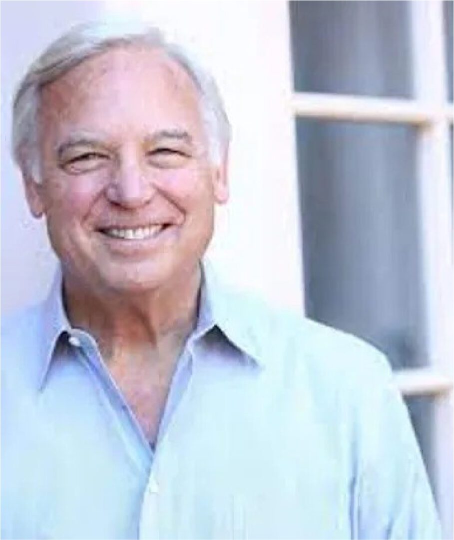 A man with grey hair smiling for the camera.