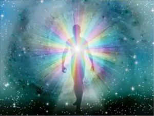 A person is standing in the light of a rainbow.